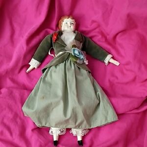 Tudor Porcelain-Head Doll in Olive Green Dress with Pink Backdrop